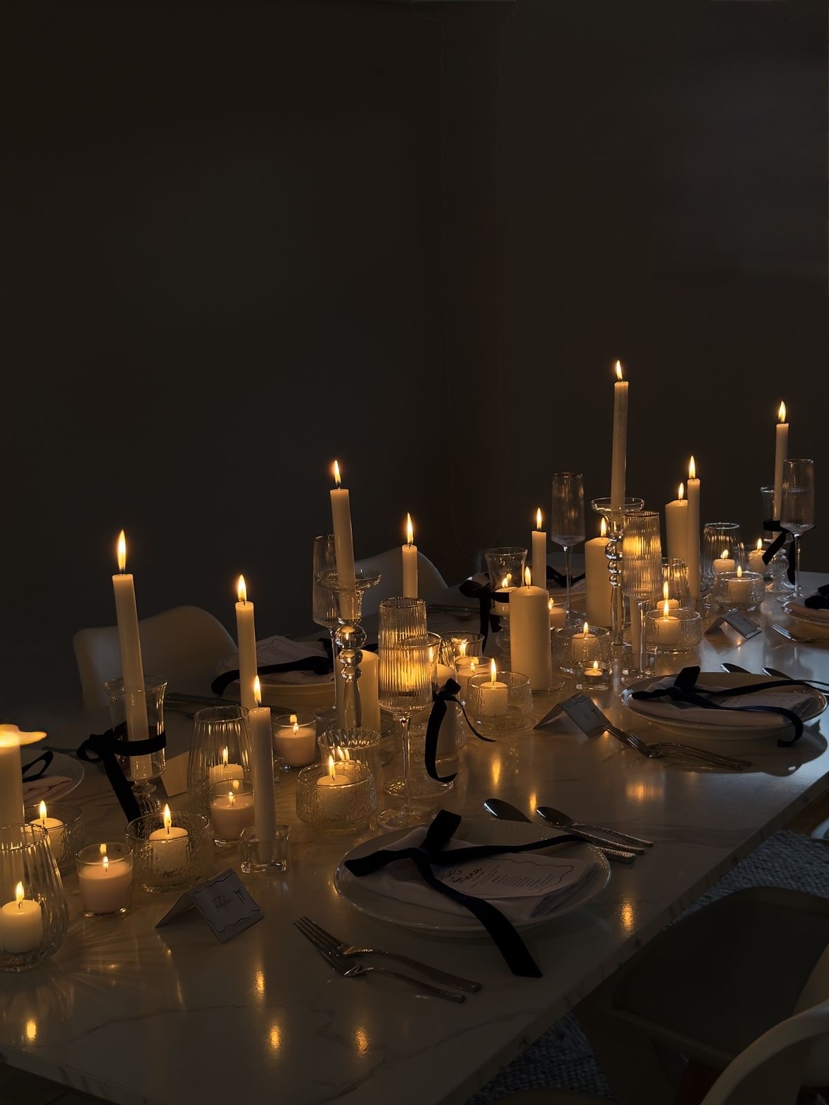 Candlelit dinner table set for conversation